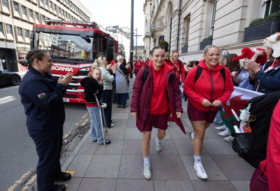 180426 - Wales v France, Guinness Women’s 6 Nations - Fire Fighter and Welsh International Jenni Scoble, who is on duty today rather than playing in the match, greets her team mates as they walk to the stadium