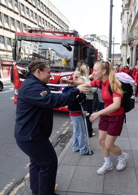 180426 - Wales v France, Guinness Women’s 6 Nations - Fire Fighter and Welsh International Jenni Scoble, who is on duty today rather than playing in the match, greets her team mates as they walk to the stadium