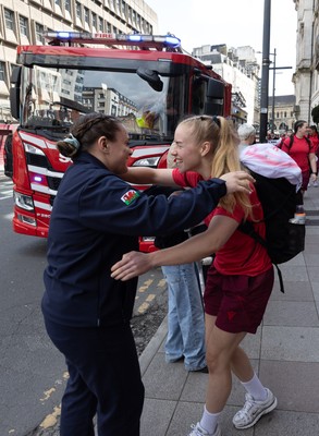 180426 - Wales v France, Guinness Women’s 6 Nations - Fire Fighter and Welsh International Jenni Scoble, who is on duty today rather than playing in the match, greets her team mates as they walk to the stadium
