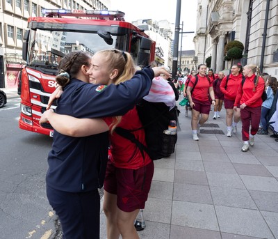 180426 - Wales v France, Guinness Women’s 6 Nations - Fire Fighter and Welsh International Jenni Scoble, who is on duty today rather than playing in the match, greets her team mates as they walk to the stadium