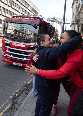 180426 - Wales v France, Guinness Women’s 6 Nations - Fire Fighter and Welsh International Jenni Scoble, who is on duty today rather than playing in the match, greets her team mates as they walk to the stadium