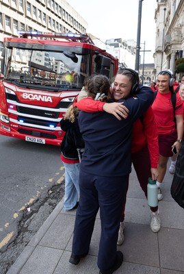 180426 - Wales v France, Guinness Women’s 6 Nations - Fire Fighter and Welsh International Jenni Scoble, who is on duty today rather than playing in the match, greets her team mates as they walk to the stadium