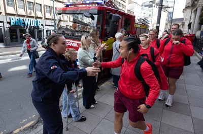 180426 - Wales v France, Guinness Women’s 6 Nations - Fire Fighter and Welsh International Jenni Scoble, who is on duty today rather than playing in the match, greets her team mates as they walk to the stadium