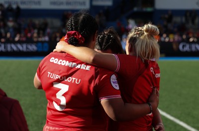 180426 - Wales v France, Guinness Women’s 6 Nations - Sisilia Tuipulotu of Wales and Kelsey Jones of Wales with Courtney Keight of Wales at the end of the match