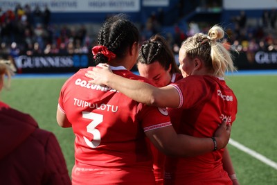 180426 - Wales v France, Guinness Women’s 6 Nations - Sisilia Tuipulotu of Wales and Kelsey Jones of Wales with Courtney Keight of Wales at the end of the match