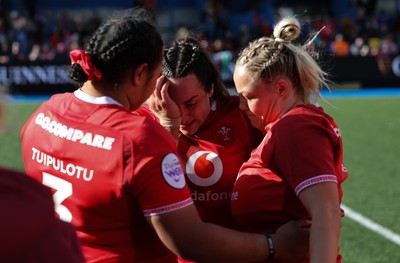180426 - Wales v France, Guinness Women’s 6 Nations - Sisilia Tuipulotu of Wales and Kelsey Jones of Wales with Courtney Keight of Wales at the end of the match