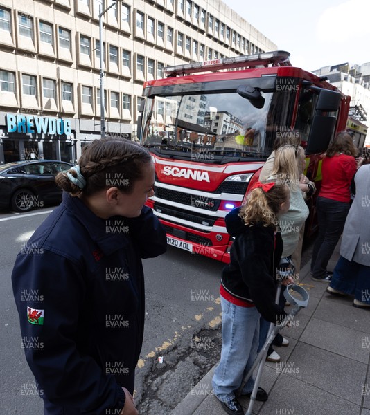 180426 - Wales v France, Guinness Women’s 6 Nations - Fire Fighter and Welsh International Jenni Scoble, who is on duty today rather than playing in the match, greets her team mates as they walk to the stadium