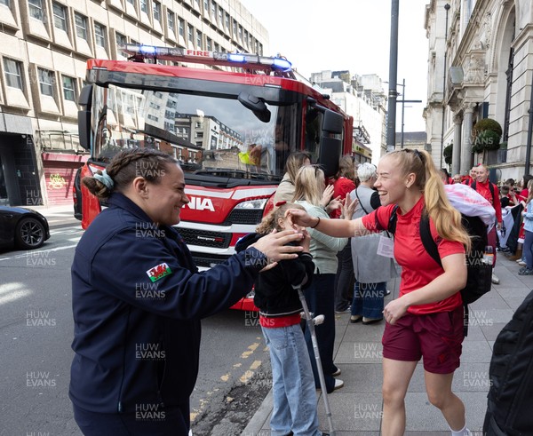 180426 - Wales v France, Guinness Women’s 6 Nations - Fire Fighter and Welsh International Jenni Scoble, who is on duty today rather than playing in the match, greets her team mates as they walk to the stadium