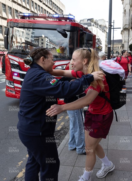 180426 - Wales v France, Guinness Women’s 6 Nations - Fire Fighter and Welsh International Jenni Scoble, who is on duty today rather than playing in the match, greets her team mates as they walk to the stadium