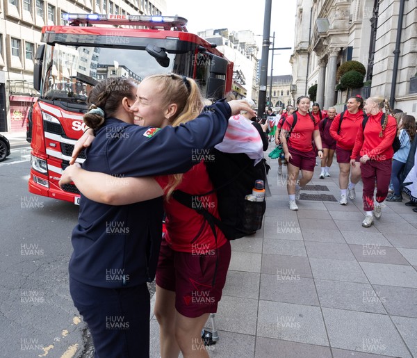 180426 - Wales v France, Guinness Women’s 6 Nations - Fire Fighter and Welsh International Jenni Scoble, who is on duty today rather than playing in the match, greets her team mates as they walk to the stadium