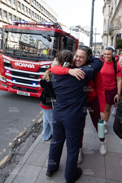 180426 - Wales v France, Guinness Women’s 6 Nations - Fire Fighter and Welsh International Jenni Scoble, who is on duty today rather than playing in the match, greets her team mates as they walk to the stadium