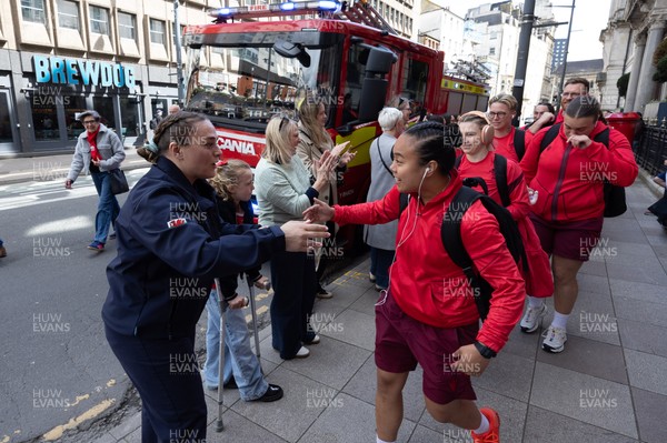 180426 - Wales v France, Guinness Women’s 6 Nations - Fire Fighter and Welsh International Jenni Scoble, who is on duty today rather than playing in the match, greets her team mates as they walk to the stadium
