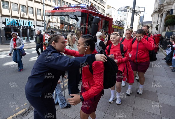 180426 - Wales v France, Guinness Women’s 6 Nations - Fire Fighter and Welsh International Jenni Scoble, who is on duty today rather than playing in the match, greets her team mates as they walk to the stadium