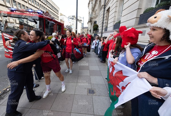 180426 - Wales v France, Guinness Women’s 6 Nations - Fire Fighter and Welsh International Jenni Scoble, who is on duty today rather than playing in the match, greets her team mates as they walk to the stadium