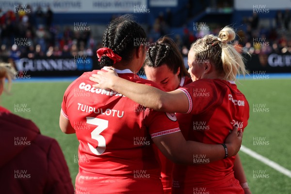 180426 - Wales v France, Guinness Women’s 6 Nations - Sisilia Tuipulotu of Wales and Kelsey Jones of Wales with Courtney Keight of Wales at the end of the match