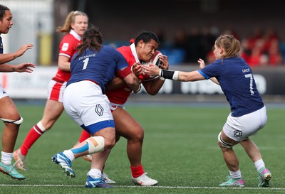 210424 - Wales v France, Guinness Women’s 6 Nations - Sisilia Tuipulotu of Wales takes on Annaelle Deshaye of France and Emeline Gros of France