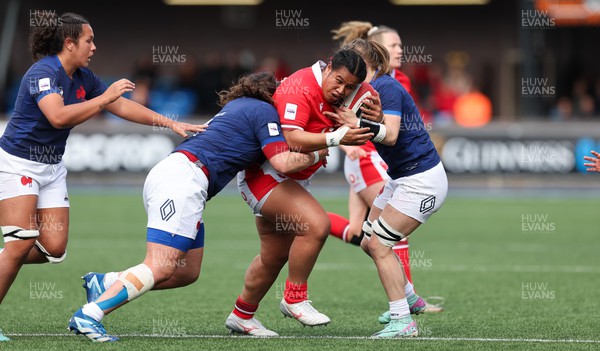 210424 - Wales v France, Guinness Women’s 6 Nations - Sisilia Tuipulotu of Wales takes on Annaelle Deshaye of France and Emeline Gros of France