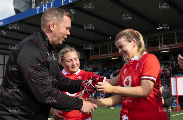 210424 - Wales v France, Guinness Women’s 6 Nations - Ioan Cunningham, Wales Women head coach, presents Mollie Wilkinson of Wales with her first cap at the end of the match