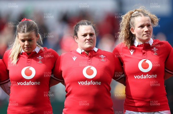 210424 - Wales v France, Guinness Women’s 6 Nations - Mollie Wilkinson of Wales, Abbey Constable of Wales and Carys Cox of Wales line up for the anthems
