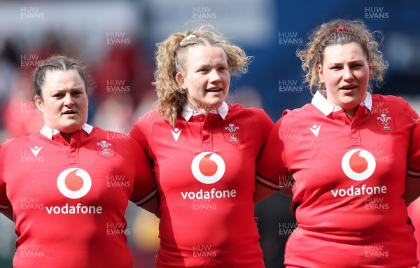 210424 - Wales v France, Guinness Women’s 6 Nations - Abbey Constable of Wales, Carys Cox of Wales and Gwenllian Pyrs of Wales line up for the anthems