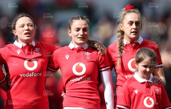 210424 - Wales v France, Guinness Women’s 6 Nations - Alisha Butchers of Wales, Jasmine Joyce of Wales and Hannah Jones of Wales with the match day mascot line up for the anthems