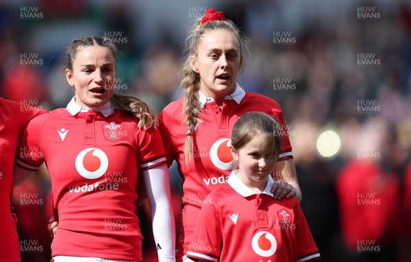 210424 - Wales v France, Guinness Women’s 6 Nations - Jasmine Joyce of Wales and Hannah Jones of Wales with the match day mascot line up for the anthems
