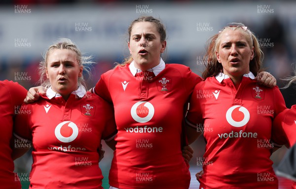 210424 - Wales v France, Guinness Women’s 6 Nations - Alex Callender of Wales, Natalia John of Wales and Georgia Evans of Wales line up for the anthems