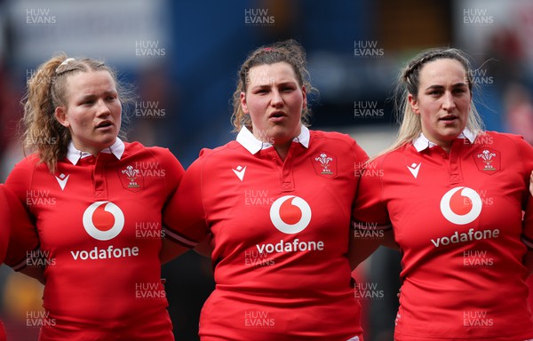 210424 - Wales v France, Guinness Women’s 6 Nations - Carys Cox of Wales, Gwenllian Pyrs of Wales and Courtney Keight of Wales line up for the anthems