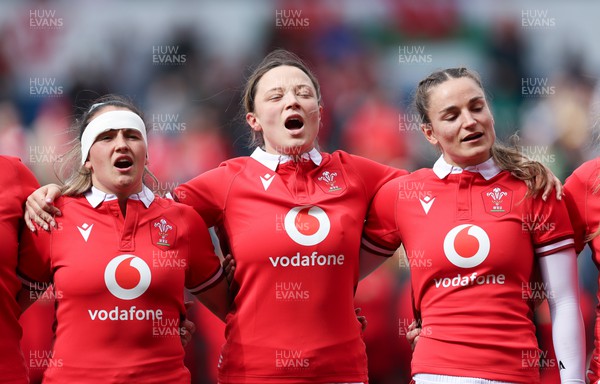 210424 - Wales v France, Guinness Women’s 6 Nations - Kayleigh Powell of Wales, Alisha Butchers of Wales and Jasmine Joyce of Wales line up for the anthems