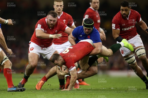 220220 - Wales v France - Guinness 6 Nations - Gareth Davies of Wales is tackled by Gregory Alldritt of France