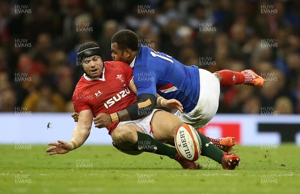 220220 - Wales v France - Guinness 6 Nations - Virimi Vakatawa of France knocks the ball out of Leigh Halfpenny of Wales hand as he tackles him