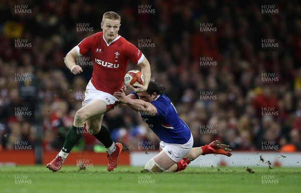220220 - Wales v France - Guinness 6 Nations - Johnny McNicholl of Wales is tackled by Camille Chat of France