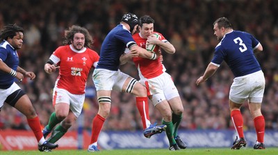 26.02.10 - Wales v France - RBS Six Nations 2010 - Stephen Jones of Wales is tackled by Julien Bonnaire of France. 