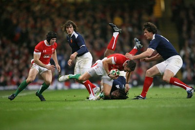 26.02.10 Wales v France... Wales' Lee Byrne is tackled by France's Mathieu Bastareaud . 