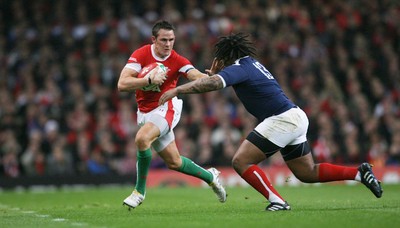 26.02.10 Wales v France... Wales' Lee Byrne is tackled by France's Mathieu Bastareaud . 