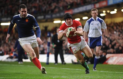 26.02.10 - Six Nations Rugby, Wales v France Wales' Leigh Halfpenny scores try as France's Julien Malzieu looks on 