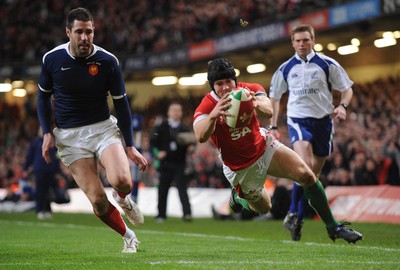 26.02.10 - Six Nations Rugby, Wales v France Wales' Leigh Halfpenny scores try as France's Julien Malzieu looks on 