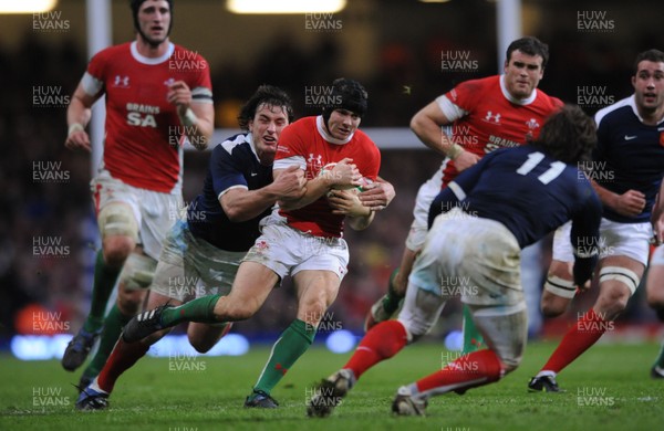 26.02.10 - Wales v France - RBS Six Nations 2010 - Leigh Halfpenny of Wales is tackled by Yannick Jauzion of France. 