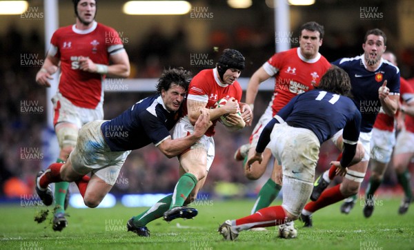 26.02.10 - Wales v France - RBS Six Nations 2010 - Leigh Halfpenny of Wales is tackled by Yannick Jauzion of France. 