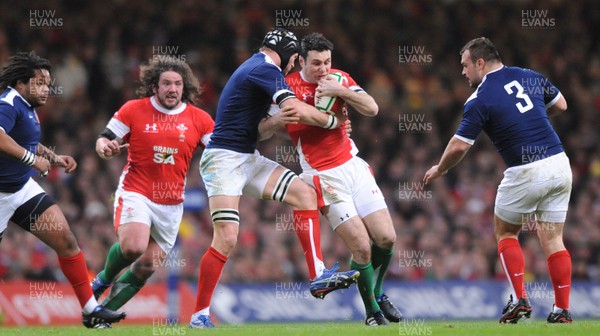 26.02.10 - Wales v France - RBS Six Nations 2010 - Stephen Jones of Wales is tackled by Julien Bonnaire of France. 