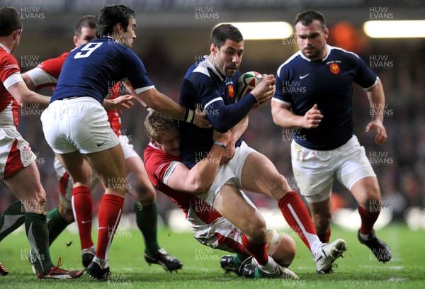 26.02.10 - Wales v France - RBS Six Nations 2010 - Julien Malzieu of France is tackled by Bradley Davies of Wales. 