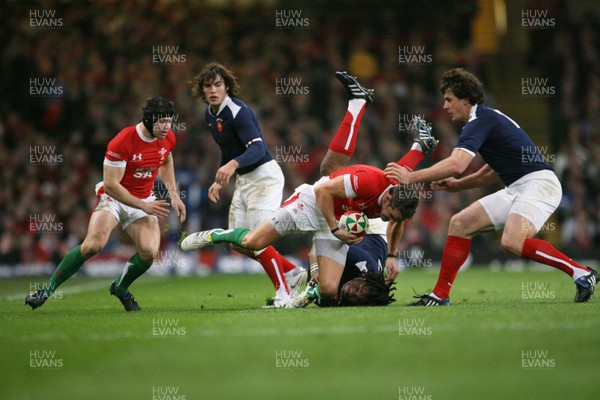 26.02.10 Wales v France... Wales' Lee Byrne is tackled by France's Mathieu Bastareaud . 