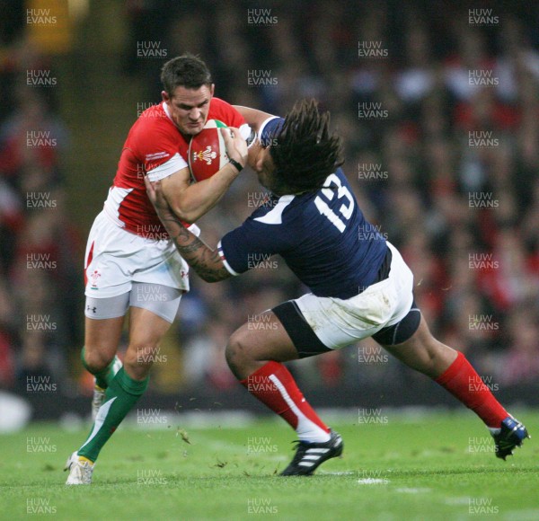 26.02.10 Wales v France... Wales' Lee Byrne is tackled by France's Mathieu Bastareaud . 