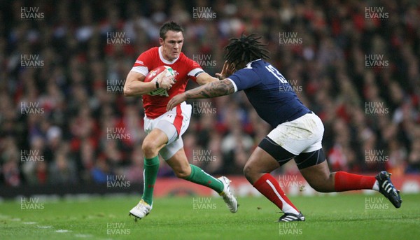26.02.10 Wales v France... Wales' Lee Byrne is tackled by France's Mathieu Bastareaud . 