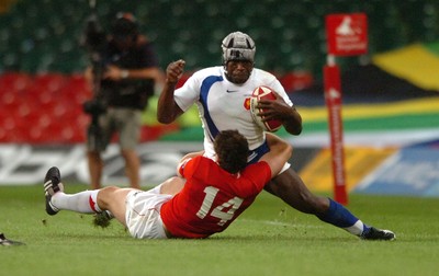 26.08.07 - Wales v France - Invesco Perpetual 2007 Summer Series - France's Serge Betsen is tackled is tackled by Mark Jones 