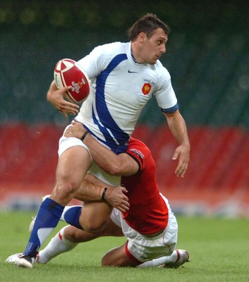 26.08.07 - Wales v France - Invesco Perpetual 2007 Summer Series - France's Lionel Beauxis is tackled by Jamie Robinson 