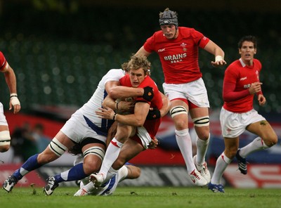 26.08.07  Wales v France... Wales Jamie Robinson is tackled by  Jerome Thion. 