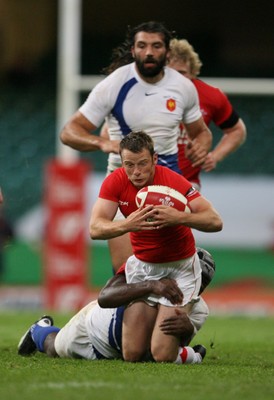 26.08.07  Wales v France... Wales Kevin Morgan is tackled by Serge Betsen. 