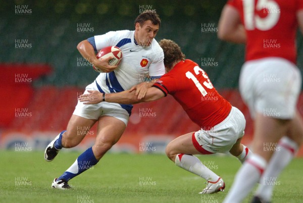 26.08.07 - Wales v France - Invesco Perpetual 2007 Summer Series - France's Lionel Beauxis is tackled by Jamie Robinson 