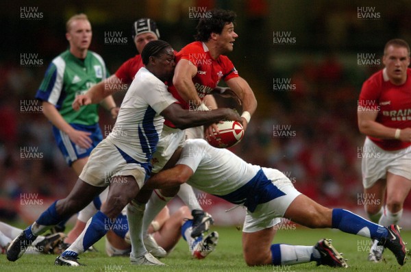 26.08.07 - Wales v France - Invesco Perpetual 2007 Summer Series - Wales' Mike Phillips is tackled by France's Jean-Baptiste Paux and France's Serge Betsen(L) 